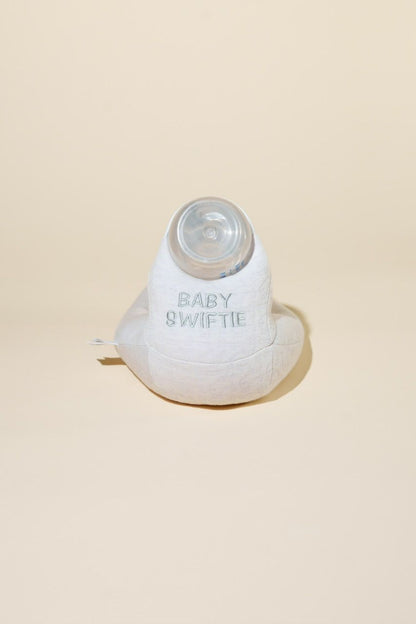 White baby bottle with 'Baby Swiftie' branding on a beige background