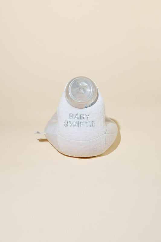 White baby bottle with 'Baby Swiftie' branding on a beige background